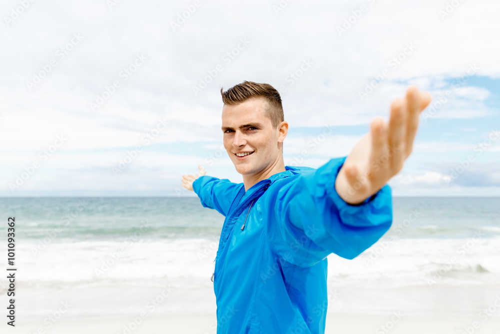 Young man in sport wear with outstretched arms Young man in sport wear with outstretched arms