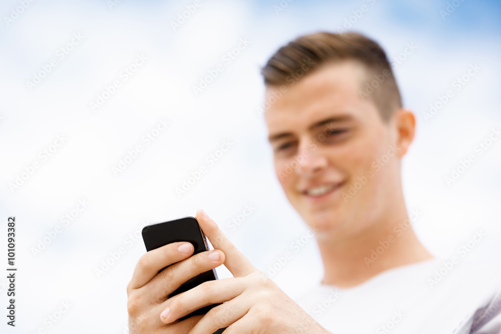 Male runner with his mobile smart phone standing outdoors Male runner with his mobile smart phone standing outdoors
