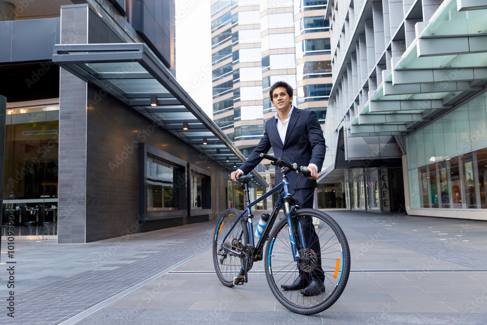 Successful businessman riding bicycle