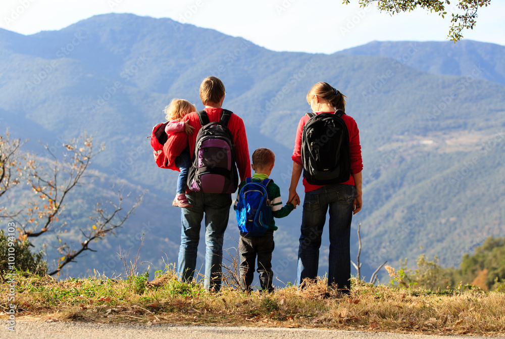 family with two kids hiking in mountains