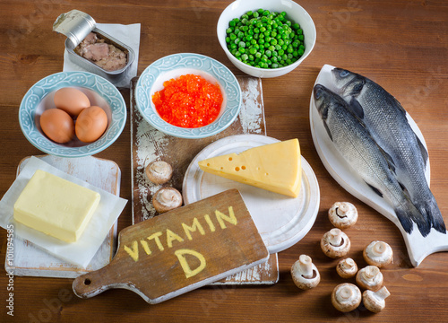 Foods highest in vitamin D on wooden background.
