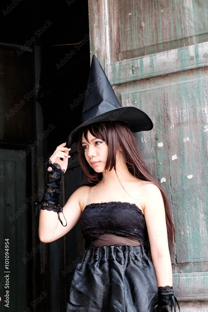 Fototapeta premium Beautiful Asian woman in witch costume for Halloween concept