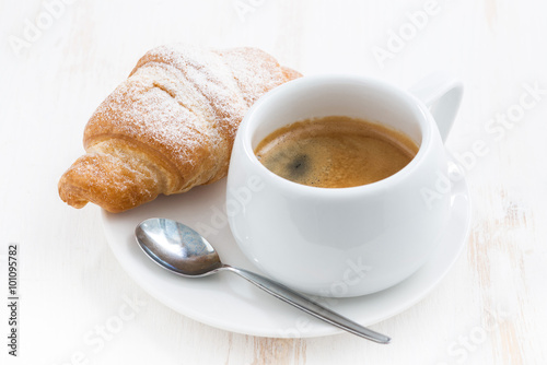 Fototapeta Naklejka Na Ścianę i Meble -  traditional breakfast with coffee and fresh croissants, closeup