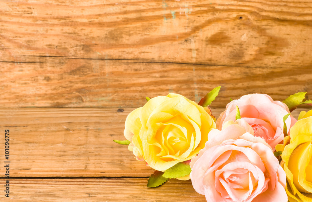 Roses flowers on wood, floral background on a vintage wooden planks useful as greeting card Roses flowers on wood, floral background on a vintage wooden planks useful as greeting card