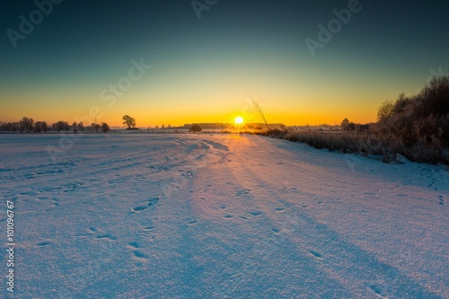 Beautiful cold morning on snowy winter countryside.