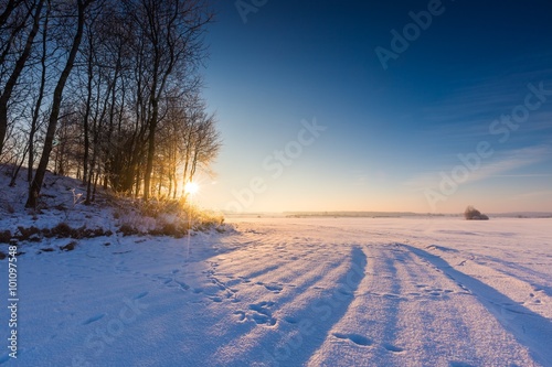 Beautiful cold morning on snowy winter countryside.