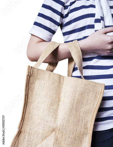 Young woman are carrying sackcloth shopping bag on white backgro