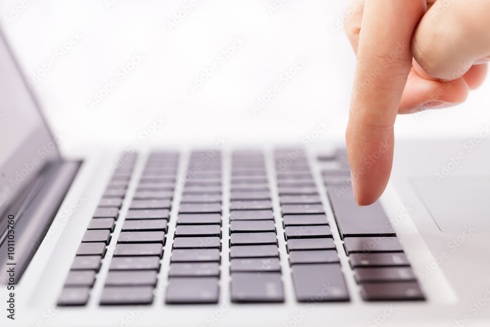 Human hands going to press a button on keypad in white isolated background