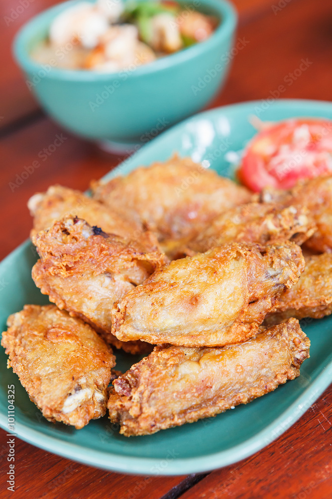 Fried chicken wings on a wooden table. thai food. Fried chicken wings on a wooden table. thai food.