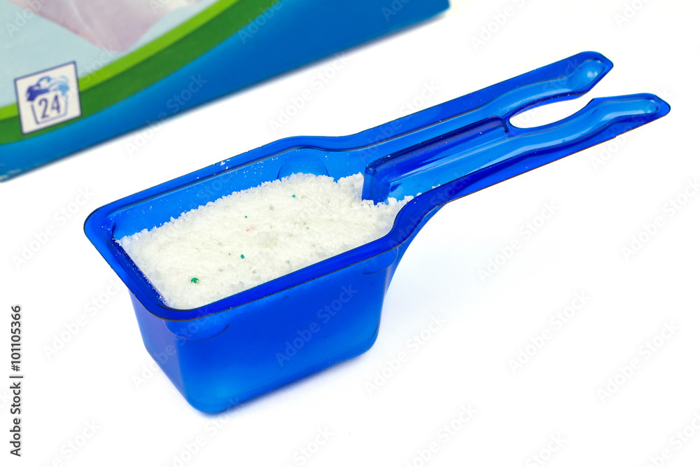 Laundry detergent or washing powder in blue measuring cup studio isolated  Stock Photo