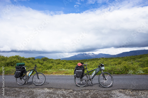 Biker rides on road at sunny summer day in Iceland