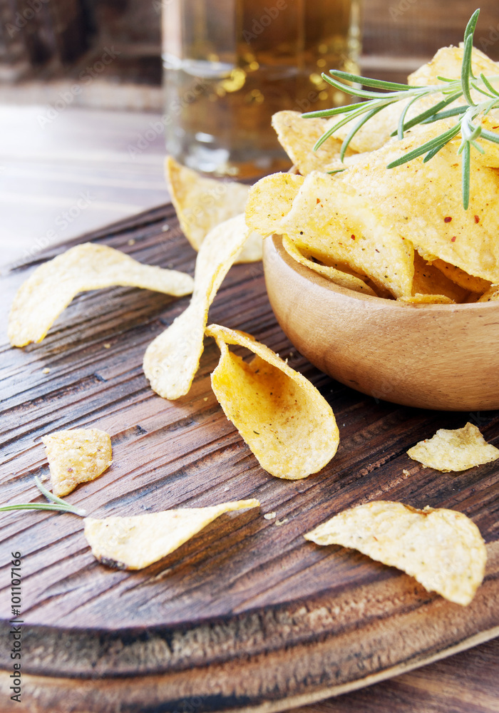 Chips in a wooden bowl and beer Chips in a wooden bowl and beer