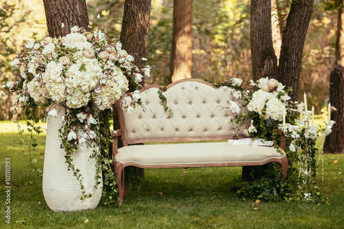 luxury wedding decorations with bench, candle and flowers compis photo