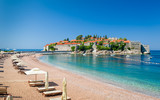 Sveti Stefan luxury sand beach with chaise-longue chairs and umbrellas