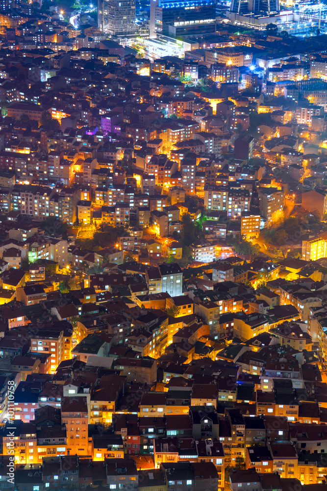 Aerial view of the city with houses and illuminated streets at