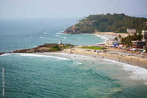 View to the beach with tourists, restaurants and hotels from lighthouse in Kovalam. Kerala, India