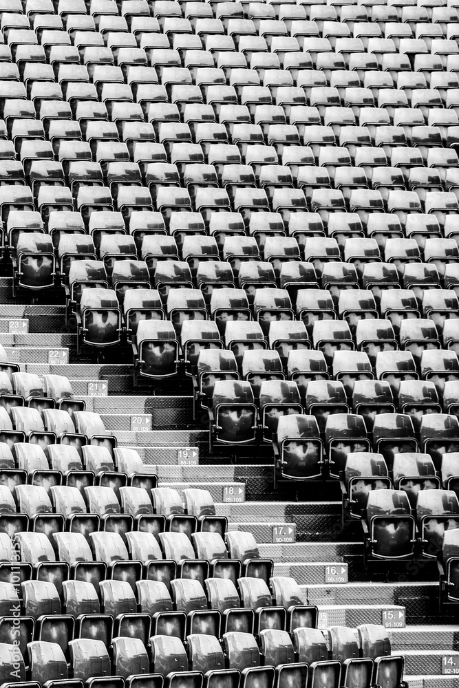 Fototapeta premium Row of seats black and white image at stadium background and texture.