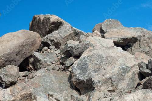 granite stones on a background of blue sky
