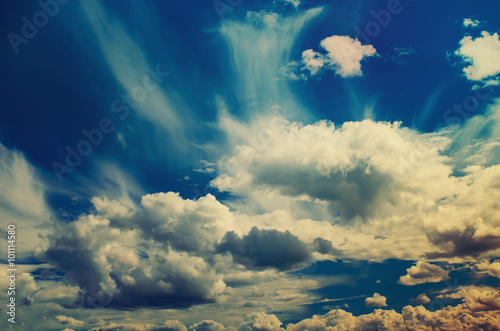 Blue sky with the fluffy white clouds, natural vintage hipster background with copy space © Roxana