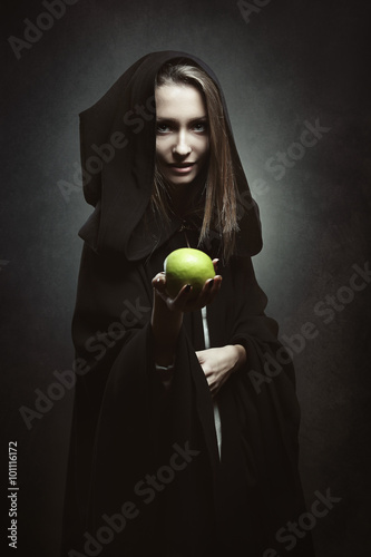 Evil queen offering a poisonous apple photo