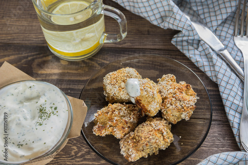 chicken nuggets oat flakes with yogurt sauce and water with lemon