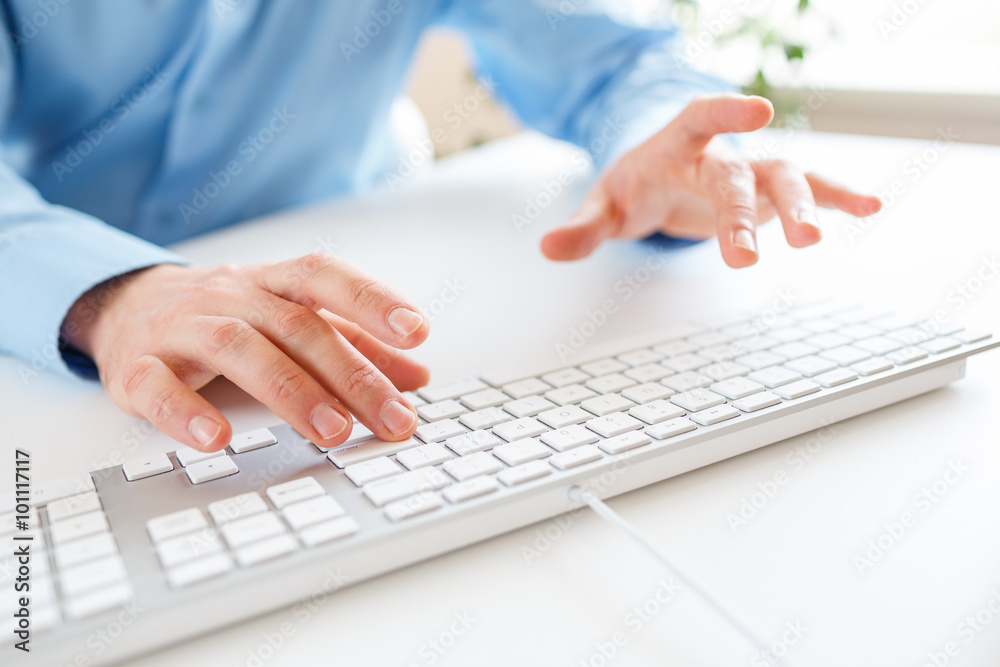 Men office worker typing on the keyboard Men office worker typing on the keyboard