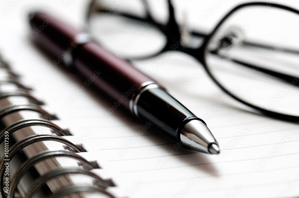 Pen and Eyeglasses on Spiral Notebook Pen and Eyeglasses on Spiral Notebook