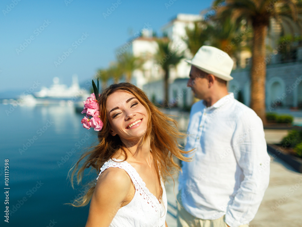 Attractive young couple walking alongside the marina - wedding c