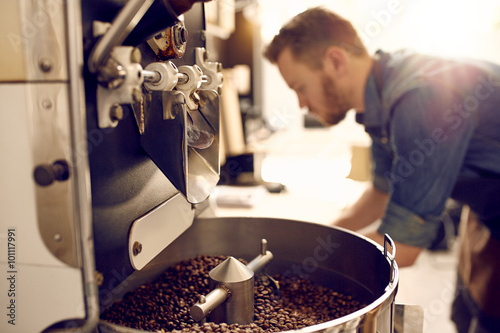 Canvas Print Freshly roasted coffee beans in a modern machine