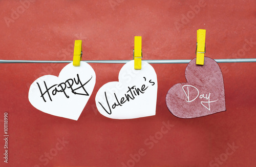 Red hearts with clothespins hanging on clothesline on color background. date, love Happy Valentines Day concept
