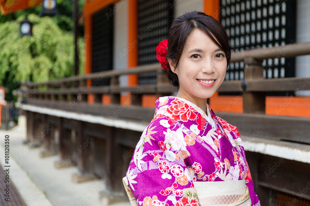 Young Woman with kimono dress at traditional temple