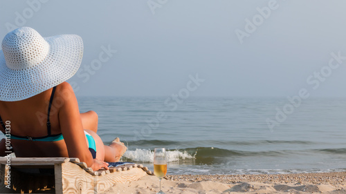 Woman on a lounger in the hat
