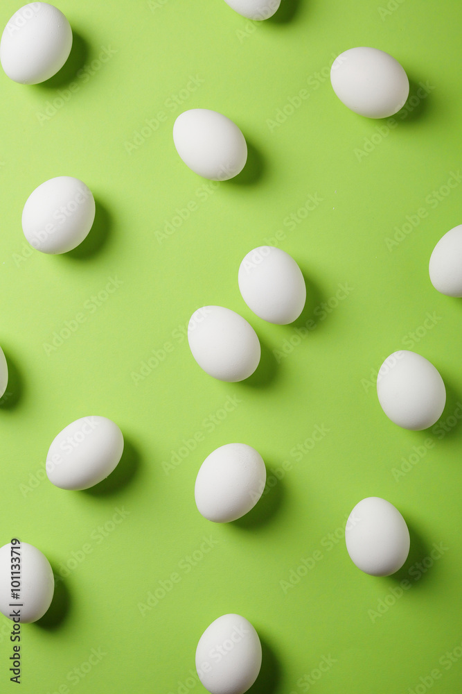 easter white eggs on green background