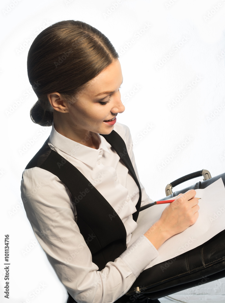 A government official writes on paper with a leather briefcase A government official writes on paper with a leather briefcase