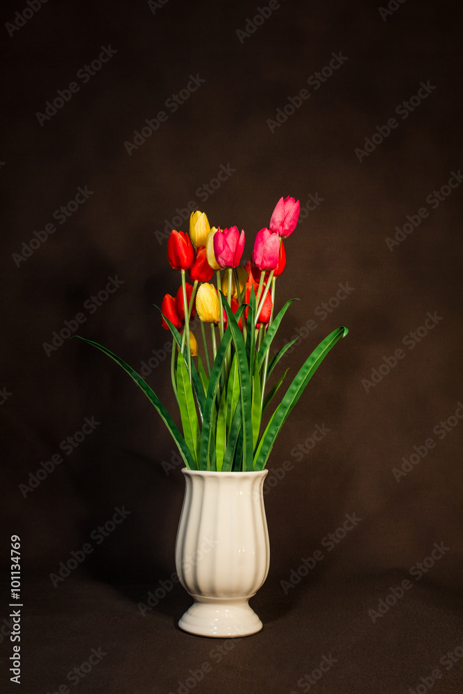 Red and Yellow and Pink tulips flower in pot on vintage backgrou