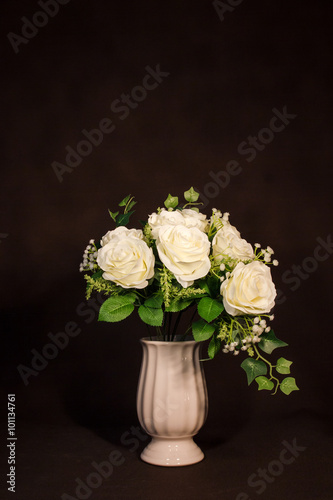 White rose flower in pot on vintage background