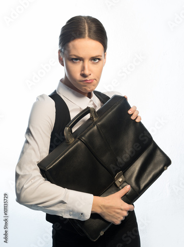 Fotografie Girl businessman holding a leather portfolio