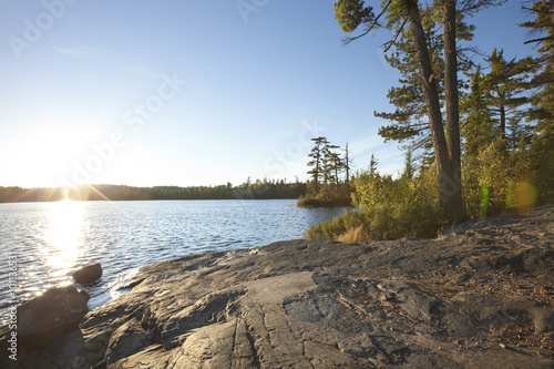 Fototapeta Naklejka Na Ścianę i Meble -  Sunset on lake with rocky shore in northern Minnesota