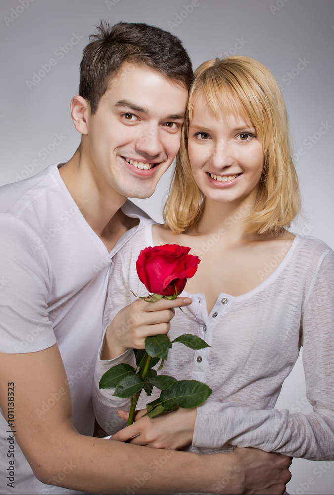 young couple of lovers. Man presents red rose for Valentine day.