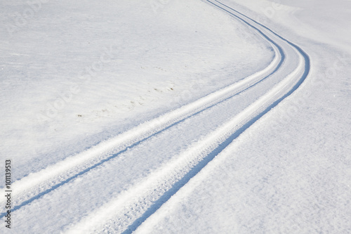Car tire track on winter road © Radomir Rezny