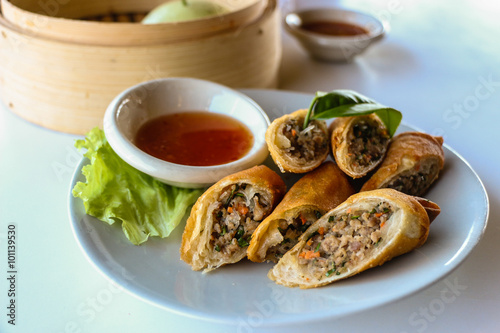 Fried vegetable spring rolls served with sweet chili sauce