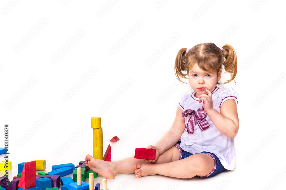 Cute baby girl playing with building blocks isolated Cute baby girl playing with building blocks isolated