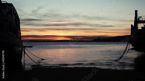 abandoned boat on the beach sunset photo