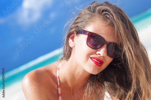 young woman with red lips and in stripy swimsuit at tropical beach © el.rudakova