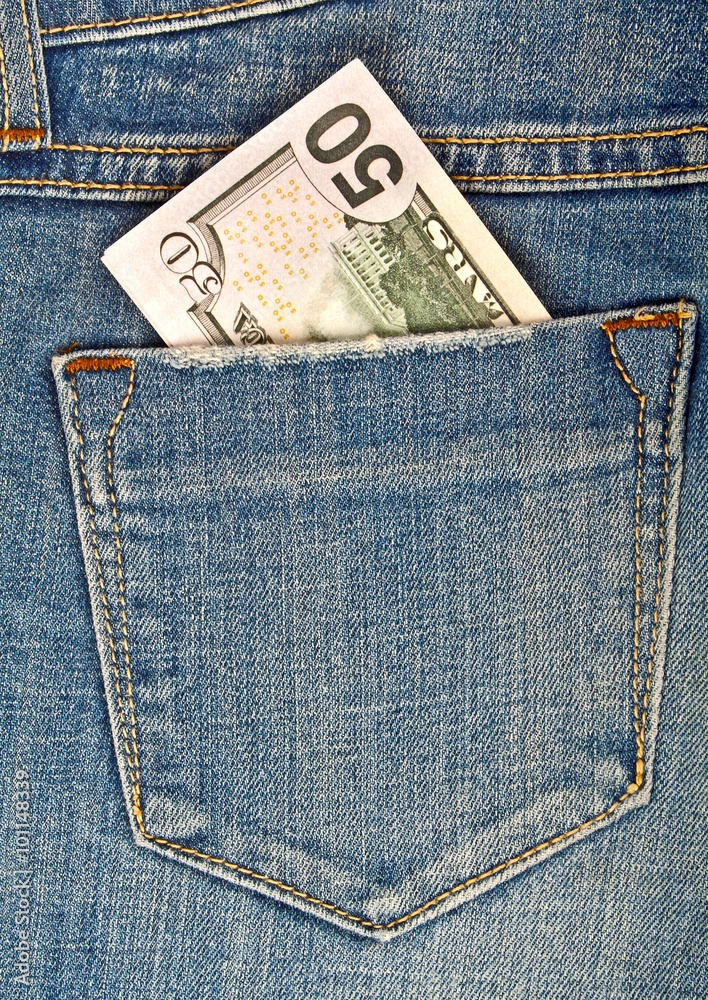 Fifty American dollars bill sticking out of the back jeans pocke Fifty American dollars bill sticking out of the back jeans pocke