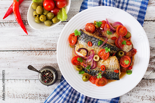Grilled mackerel with vegetables in Mediterranean style. Top view photo