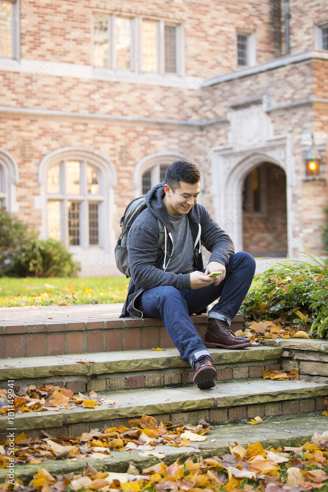 Mixed race college student sitting on campus steps Mixed race college student sitting on campus steps