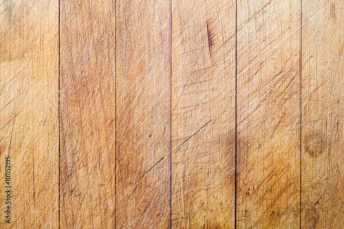 Rough wooden used cutting board background with vertical lines and cutting traces