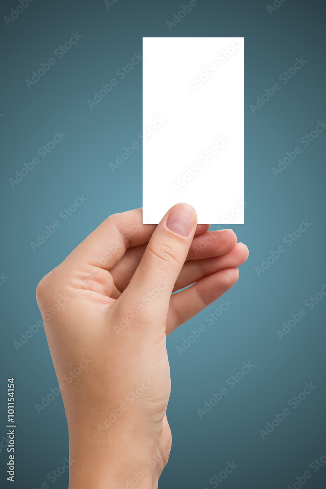 Hand holding white blank business visit card, gift, ticket, pass, present isolated on blue background. Copy space for text. Corporate identity package Template ID Hand holding white blank business visit card, gift, ticket, pass, present isolated on blue background. Copy space for text. Corporate identity package Template ID