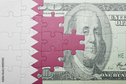 puzzle with the national flag of qatar and dollar banknote